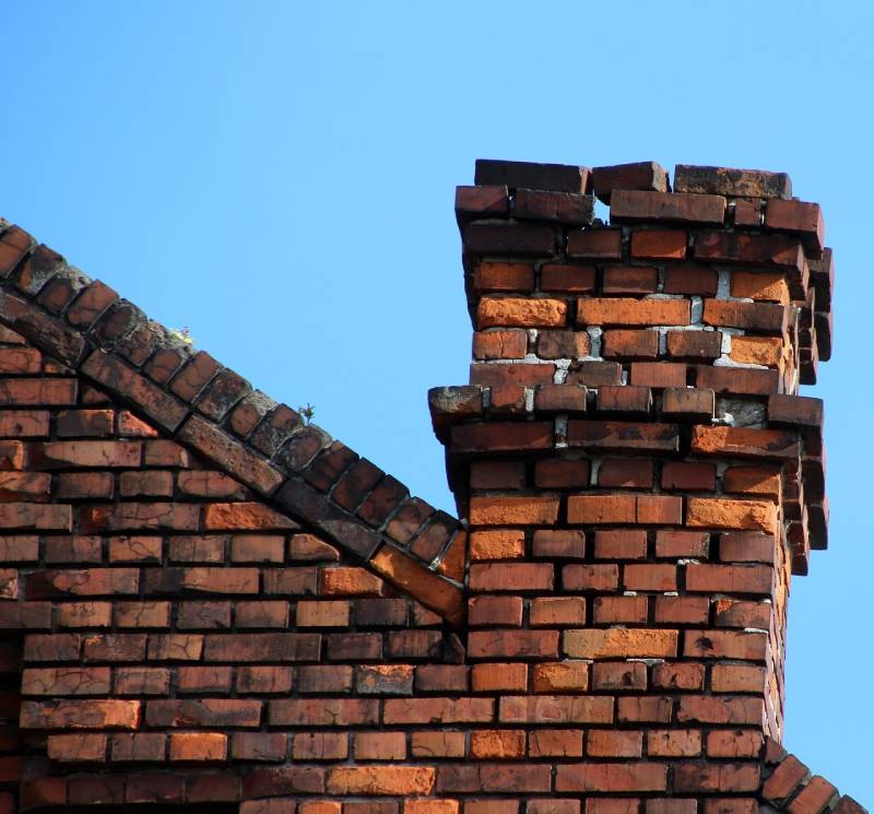 Signs Your Pikesville Home Needs a Chimney Inspection Blog Article - Damaged chimney on an Pikesville home showing cracks and missing mortar